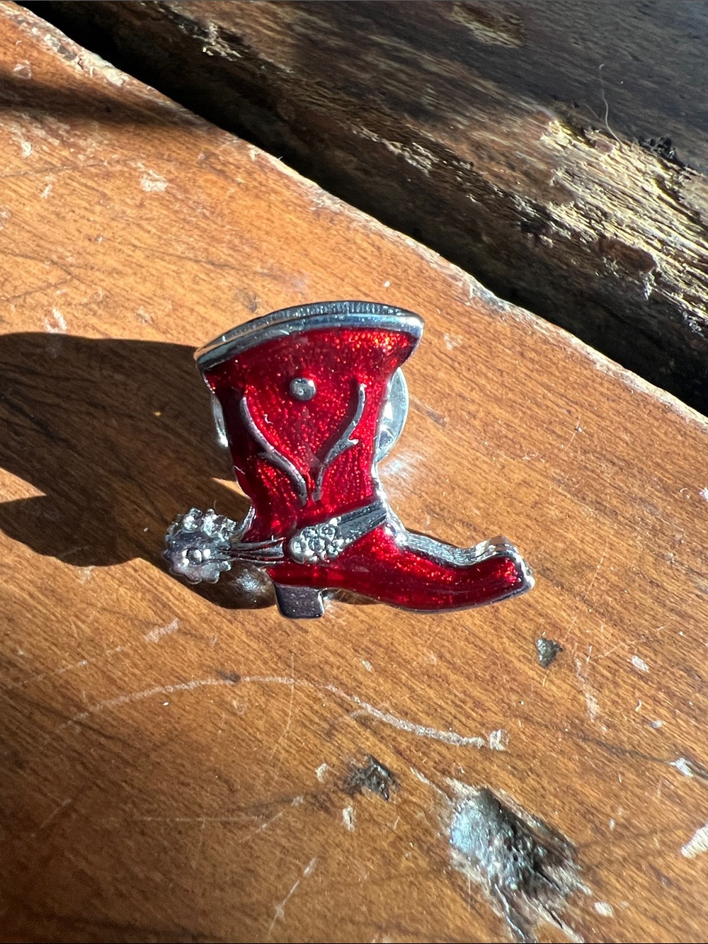 Vintage red enamel western cowboy boot lapel pin featuring a silver-tone spur
